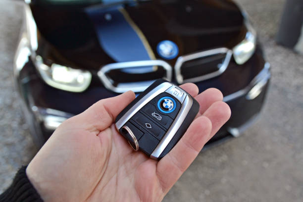 Key to the electric BMW in a hand Bratislava, Slovakia - 24th February, 2018: Elegant and modern key to the electric BMW i3 in a hand. The BMW vehicles are the one of the most popular luxury cars in the world. bmw stock pictures, royalty-free photos & images