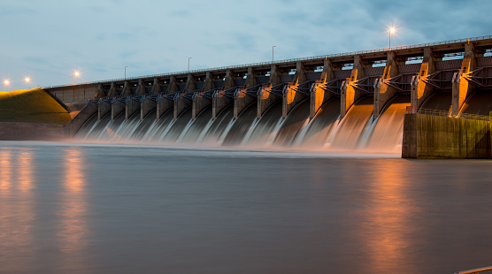 The Keystone Dam in Oklahoma with all the gates open and flowing a lot of water.  Shot at Twilight. 