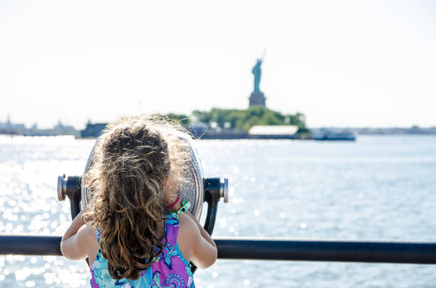 Kid looking at Statue of Liberty stock photo