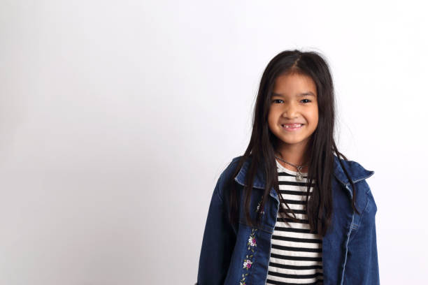 Kid The Asian girl standing on the white background. philippine girl stock pictures, royalty-free photos & images