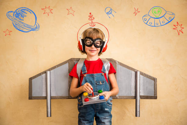 Kid pilot with toy jetpack playing at home stock photo