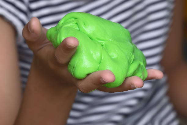 Kid Playing Hand Made Toy Called Slime, Experiment Scientific Method stock photo