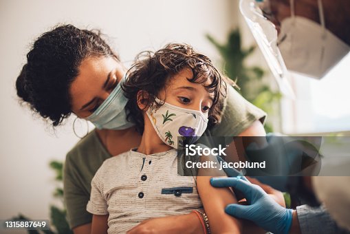 istock Kid receiving covid vaccine at home 1315887649