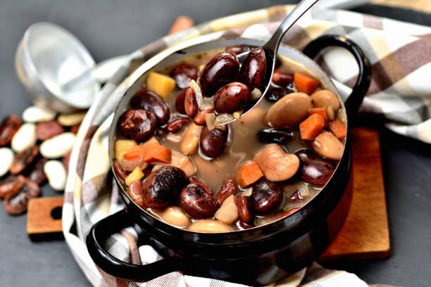 Kidney bean soup with large beans in an old enamel pot. stock photo