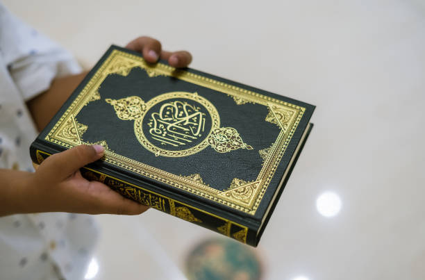 Kids hand holding Al-Quran Kids hand holding Al-Quran alquran stock pictures, royalty-free photos & images