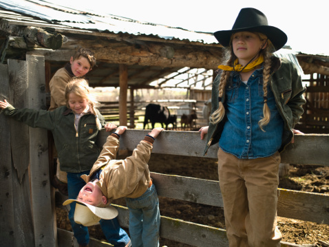 Young cowboys and cowgirls hanging out at corral
