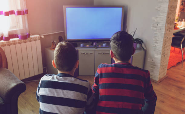 KIds in front of TV stock photo