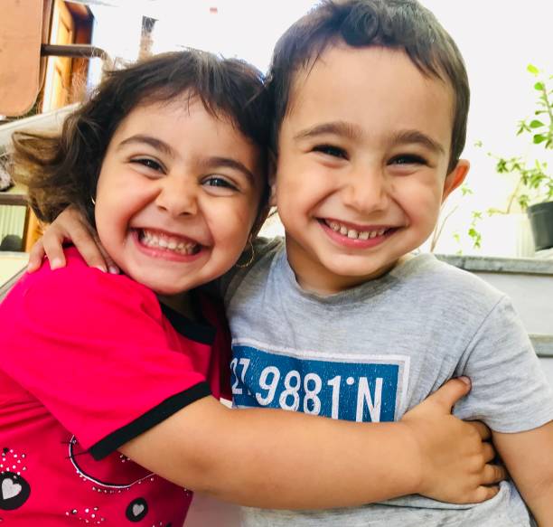 Kids love friendship happiness affectionate togetherness smiling Kids love friendship happiness affectionate togetherness smiling cute arab girls stock pictures, royalty-free photos & images