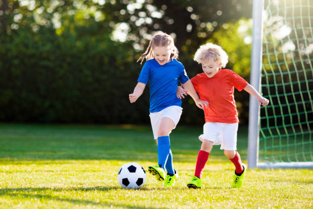 kids play football. child at soccer field. - boys football boots 個照片及圖片檔