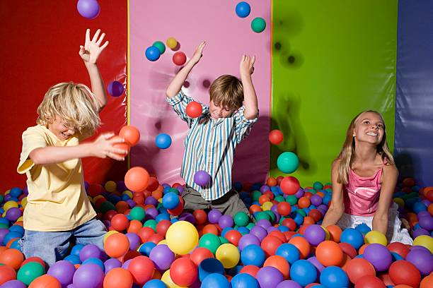 Kids playing in ball pool  indoor playground stock pictures, royalty-free photos & images