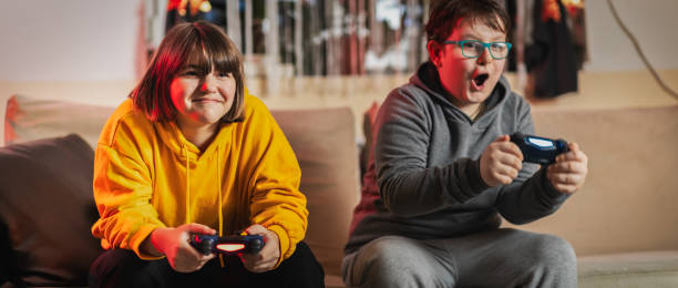 Kids playing multiplayer online games stock photo