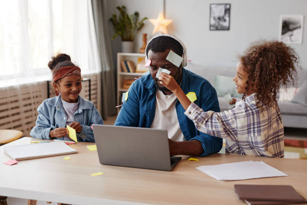 Kids Playing with Father in Online Meeting stock photo