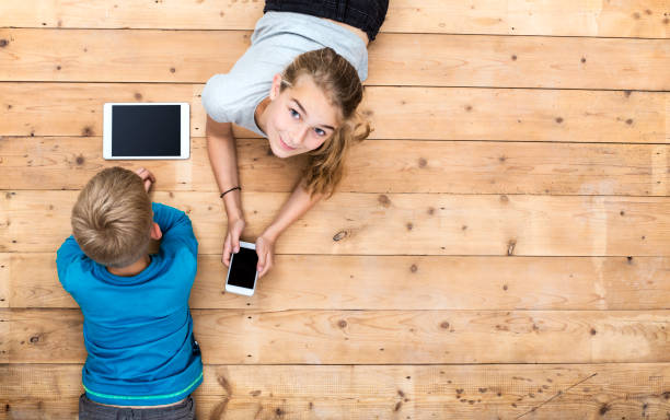 Kids playing with mobile devices header stock photo
