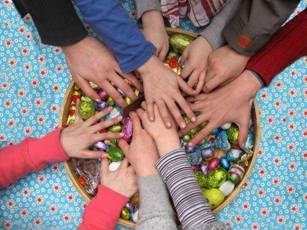 Kids share Easter eggs Children share Easter eggs easter sunday stock pictures, royalty-free photos & images