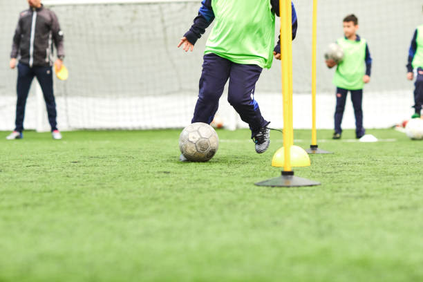 kids soccer training. indoor soccer players training with balls - futsal imagens e fotografias de stock