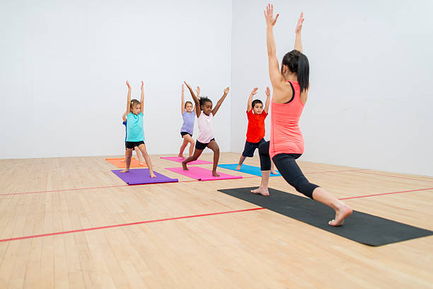 Young Woman Teaching Kids Yoga Stock Photos, Pictures