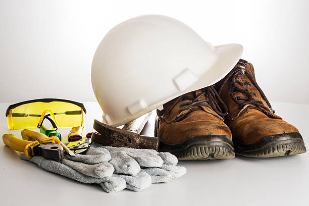 Kit of tools and equipments used by an electrician. Kit of tools and equipments used by an electrician. There are a hard hat, a protective gloves, pliers, protective goggles, screwdriver, hammer and a gaiter. Everything in a white background. individual event stock pictures, royalty-free photos & images