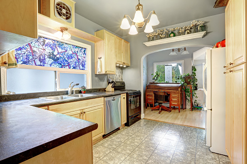 Kitchen Interior With Golden Cabinets Black And White Appliances