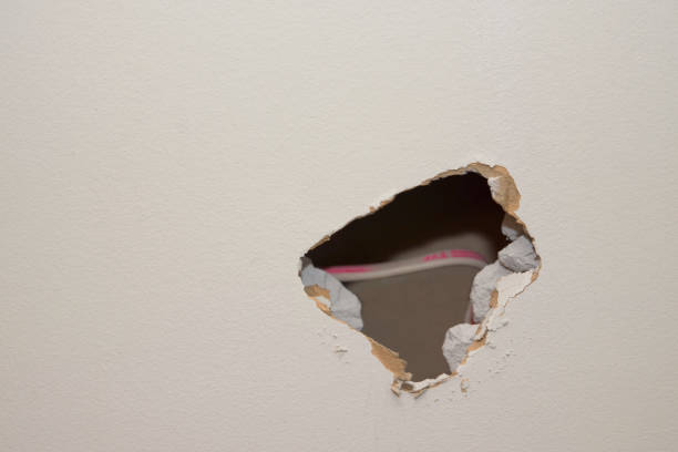 Kitchen Remodel Hole in Wall Lower Right with Wire stock photo
