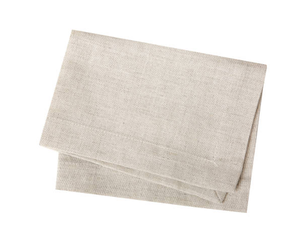 Kitchen towel isolated on white.Folded beige cloth. Kitchen towel isolated on white.Folded beige cloth.Tablecloth. napkin stock pictures, royalty-free photos & images