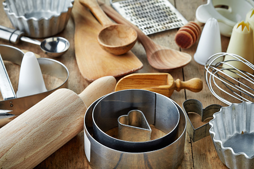 various kitchen utensils on wooden table