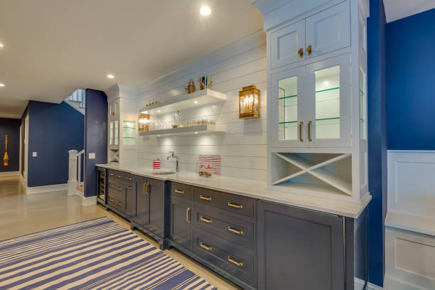 Kitchenette in basement of new home Blue painted walls and blue cabinets and blue and white rug shiplap stock pictures, royalty-free photos & images