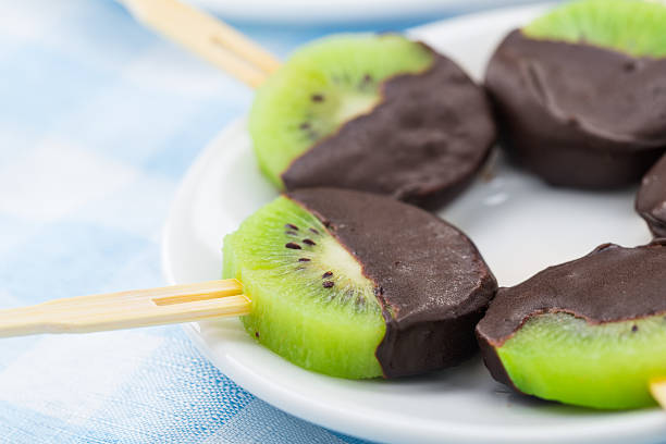 Kiwi with chocolate on a stick stock photo