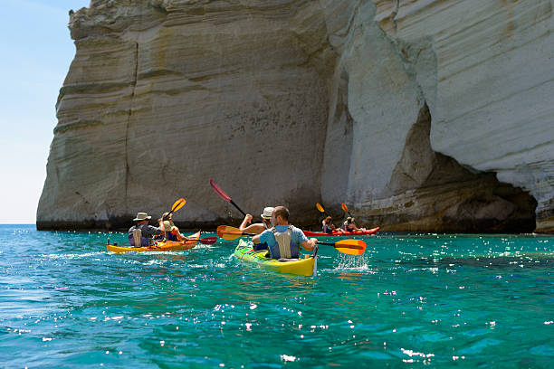 Kleftiko rock formations kayaking Melos, Greece stock photo