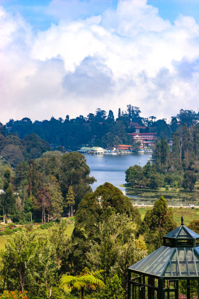 Kodaikanal, South India - Looking Down At Kodaikanal Lake From A Higher Elevation In The Colonial Town In The State Of Tamil Nadu; In The Far Background Is The Peak Known Locally As Perumal Malai stock photo
