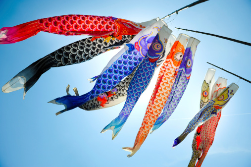 Traditional koi shaped japanese kite called koinobori against blue sky in Hiroshima.