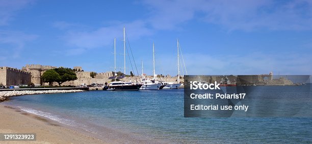 istock Kolona harbour and medieval fortified walls of the Old Town of Rhodes, Rhodes, Greece 1291323923