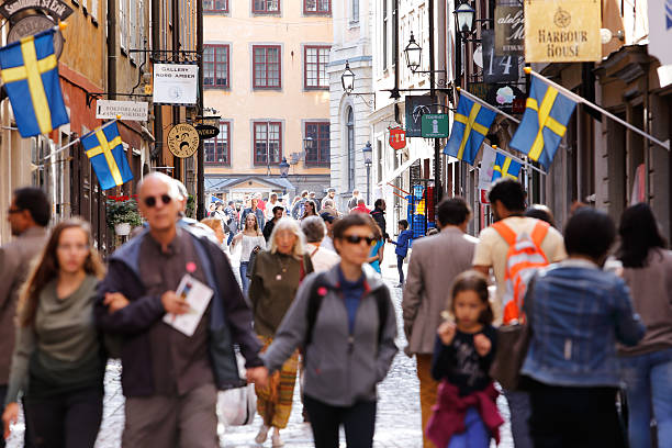 Kopmangatan Old town Stockholm, Sweden - July 31, 2015: People walking the street Kopmangatan in the Old town. swedish flag photos stock pictures, royalty-free photos & images