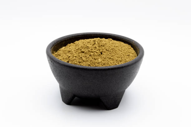 Kratom powder in black bowl isolated on a white background Bulk Kratom powder in a black bowl isolated on a white background. kratom kilo stock pictures, royalty-free photos & images