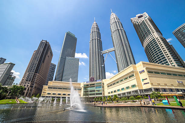 Kuala Lumpur Convention Center Kuala Lumpur, Malaysia - January 10, 2016: KLCC park, which contains the Petronas Towers and luxury hotels and shopping mall in Kuala Lumpur petronas towers stock pictures, royalty-free photos & images