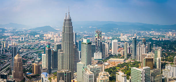 Kuala Lumpur futuristic cityscape panorama Petronas Towers iconic skyscrapers Malaysia Aerial view over the skyscrapers and landmarks of Kuala Lumpur, Malaysia's vibrant capital city, from the iconic spires of the twin Petronas Towers to the hotels and malls of Bukit Bintang. ProPhoto RGB profile for maximum color fidelity and gamut. bukit bintang stock pictures, royalty-free photos & images