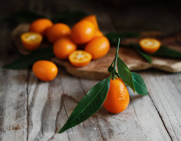 Kumquat fruits on a wooden background Kumquat fruits on a wooden background close up kumquat stock pictures, royalty-free photos & images