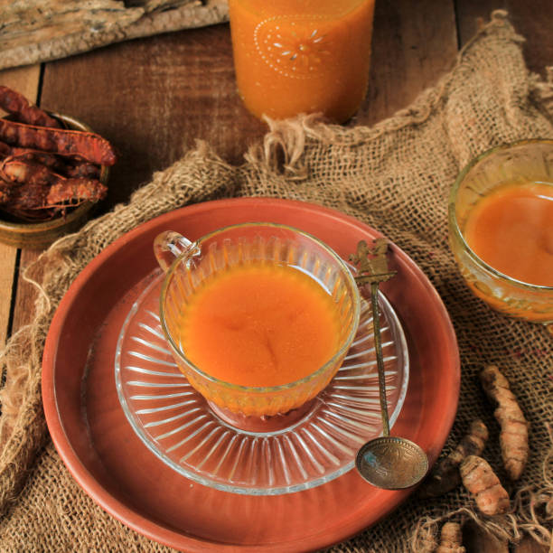 Kunyit Asam is Indonesian Traditional Herbal Drink for Women. Made from Turmeric and Tamarind and other Herbs stock photo
