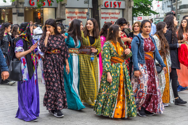 Kurdish girls and women in traditional dress at a demonstration in the pedestrian zone of downtown Hannover, Germany stock photo