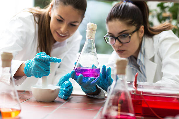 Lab Two young female scientist doing experiments in lab. chemistry class stock pictures, royalty-free photos & images