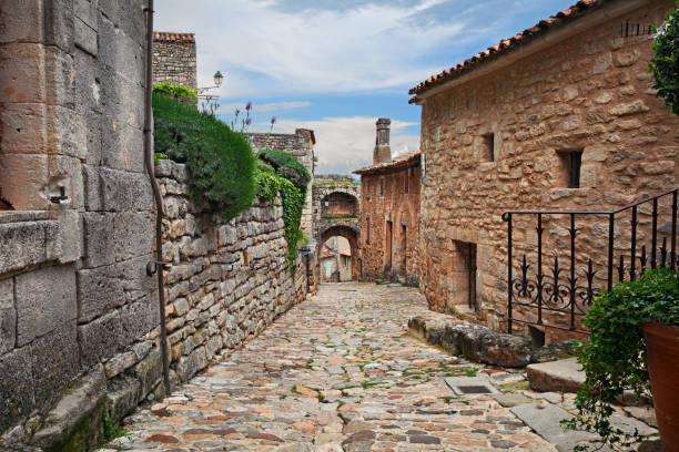 Lacoste, Vaucluse, Provence-Alpes-Cote d'Azur, France: ancient alley in the old town of the medieval village in the nature park of Luberon stock photo