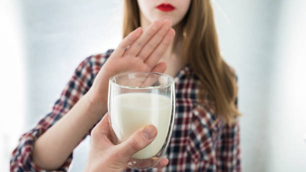 Lactose intolerance. Dairy Intolerant young girl refuses to drink milk stock photo