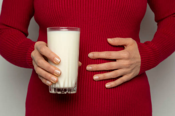 lactose intolerance. Stomach pain from milk stock photo