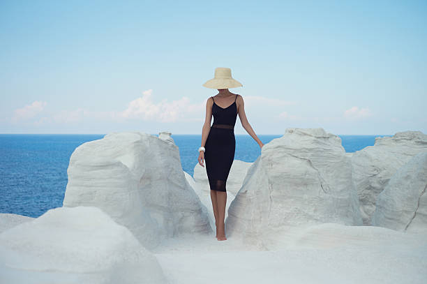 Lady in hat in an unusual landscape stock photo
