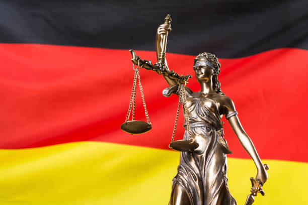 Lady justice against German flag stock photo