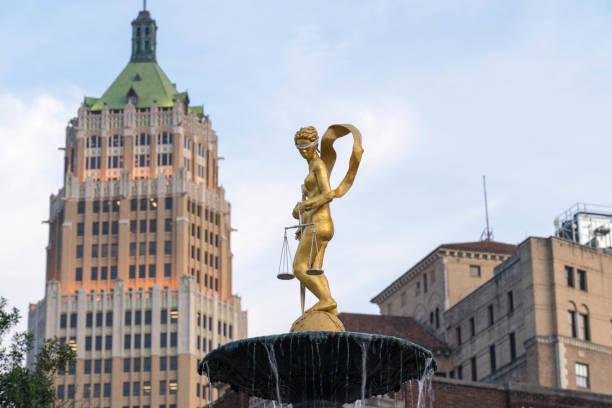 Lady Justice Statue on Water Fountain with San Antonio Downtown Building in Background stock photo