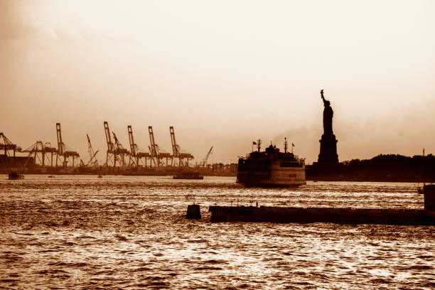 Lady Liberty and Staten Island ferry at Sunset stock photo