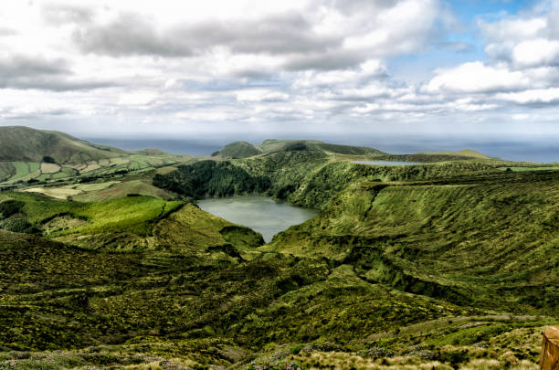 Lagoon Case (FLORES-Azores) The photograph was taken on the island of Flores (Azores) between September 5 and 9, 2020. The photograph shows the crater lake of Lagoa Funda on the island of Flores, the Azores where you can see the difference in height with respect to Lagoa Rasa.
Flores is the westernmost island of the Azores archipelago in Europe.
The island is of spectacular visual grandeur; lakes, natural pools, waterfalls, beaches, viewpoints, forests, craters ... It has been a Biosphere reserve since 2009. Along the coast there are cliffs and caves that can only be seen from a boat, to recommend the one that departs from Corvo towards Flores. Of all the ones I have visited, this is undoubtedly the most impressive. bioreserve stock pictures, royalty-free photos & images