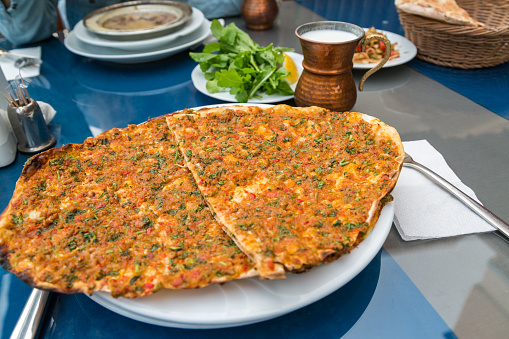 lahmacun-on-the-talbe-with-ayran-and-grrenery-picture-id679955702