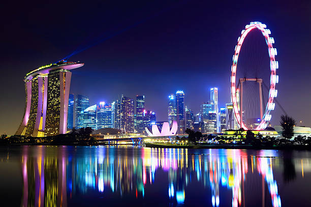 Lake reflecting the Singapore city skyline at night stock photo