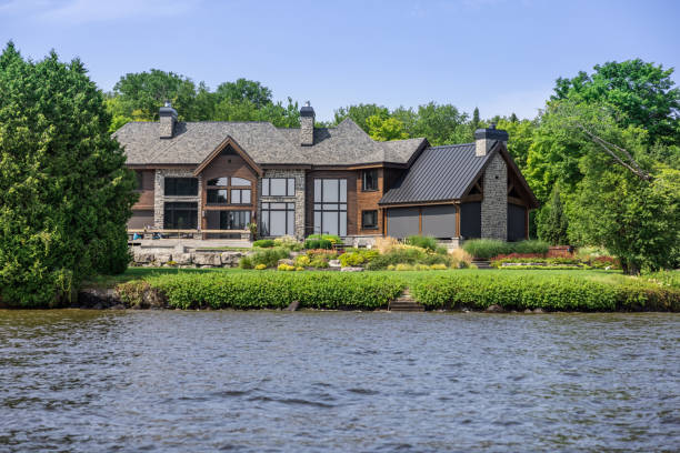 Lakefront Luxury Property on Sunny Day of Summer Lac St-Joseph, Quebec, Сanada - August 8, 2021: Luxurious lakefront property located in Lac St-Joseph, a rich suburb of Quebec City on a sunny day of summer. waterfront stock pictures, royalty-free photos & images